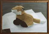 Stuffed animal fox sitting on white papers